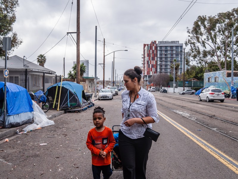 Danielle Patrice Draeving and her son JD on their way to visit her friend at an encampment on Commercial Street in downtown on March 21, 2023.