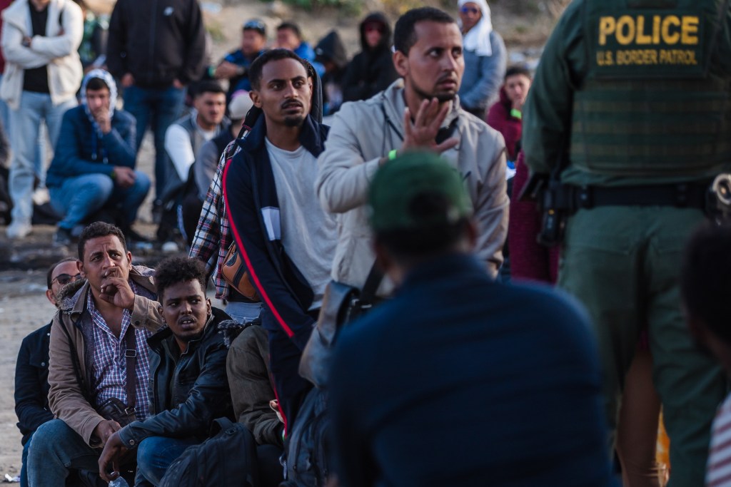 Asylum seekers from various countries wait at the US-Mexico border in San Ysidro on May 8, 2023.