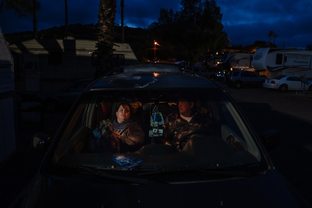Tami Grobarek and William Pendarvis sit in their broken down car in El Cajon on May 9, 2023.