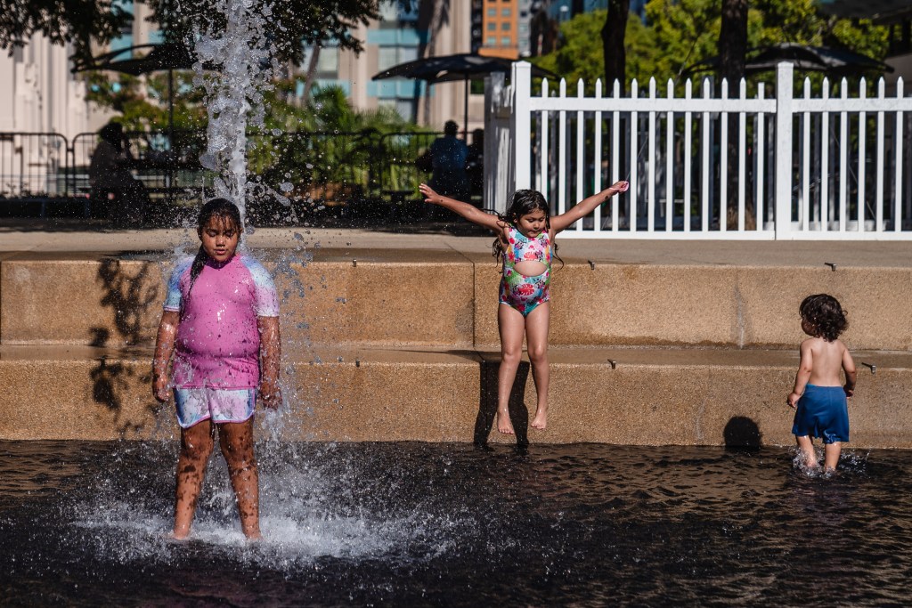 Kids play in the water at Waterfront Park on Aug. 28, 2023.