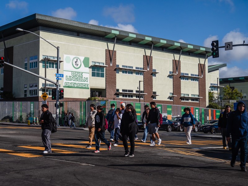 Students cross the street in front of Lincoln High School on Oct. 23 2023.