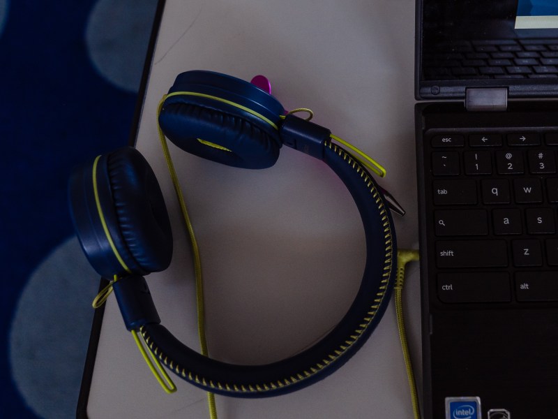 A headset next to a laptop on a student's desk at Edison Elementary School in City Heights on Feb. 15, 2024. / Ariana Drehsler for Voice of San Diego